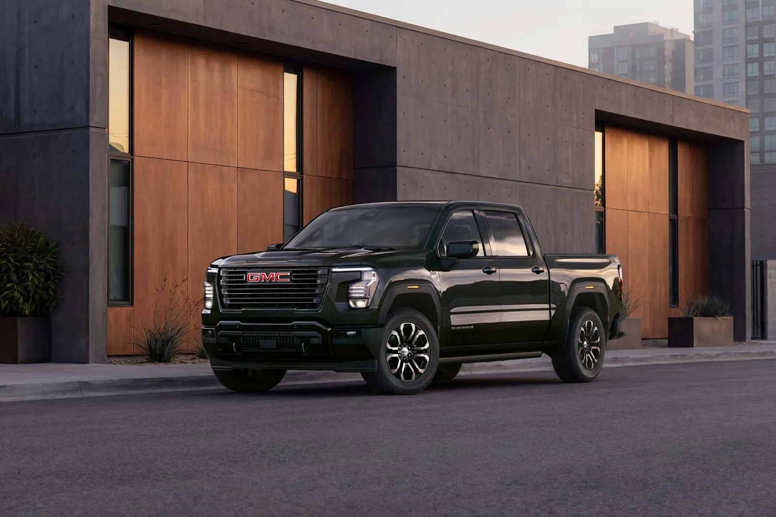 Black 2027 GMC Sierra 1500 Crew Cab parked on a city street