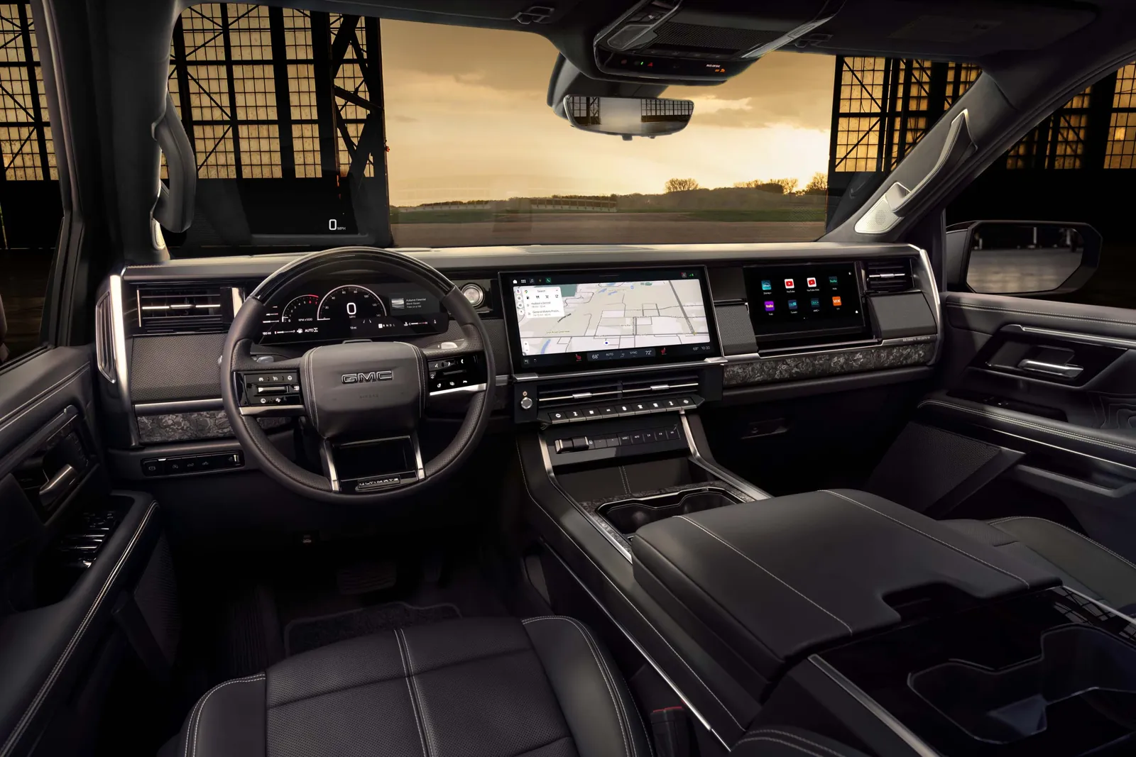2027 GMC Sierra 1500 Denali Ultimate interior with digital cluster, center screen, and passenger display